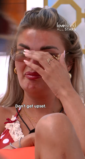 A woman crying, covering her eyes with her hand, with the text "Don't get upset" and "Love Island All Stars" logo.