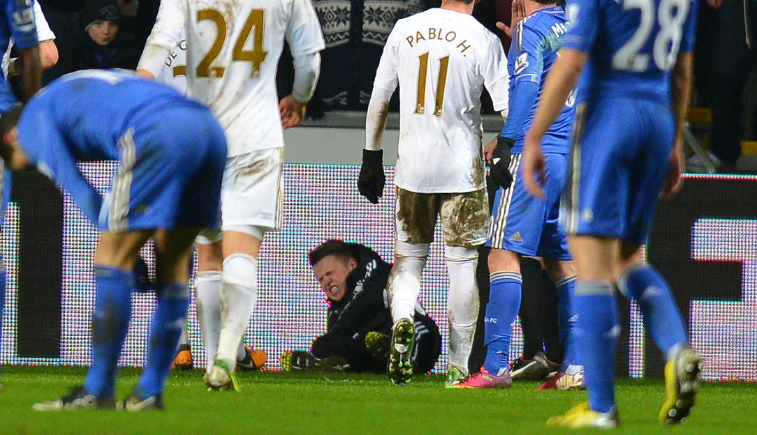 A ball boy reacting on the ground after an altercation with Eden Hazard during a football match.