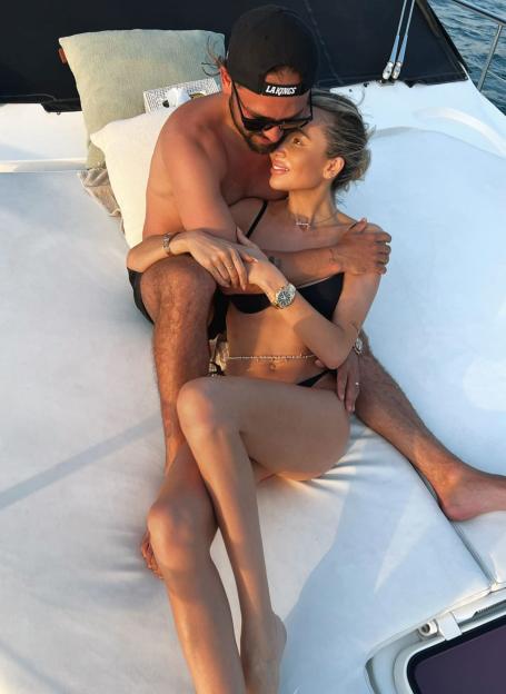 Olivia Attwood and Bradley Dack embracing on a yacht.