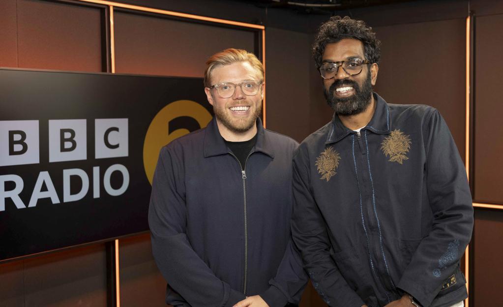 For use in UK, Ireland or Benelux countries only Handout photo issued by the BBC of Romesh Ranganathan (right) with his first guest, fellow Radio 2 presenter Rob Beckett, during his morning show on...