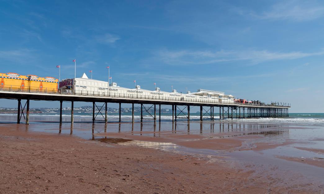 Paignton Pier in Devon, extending over the beach and into the sea.