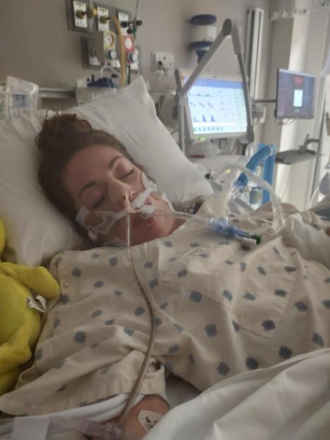 Mariah Gardner in a hospital bed with an oxygen tube in her nose and an IV in her arm.