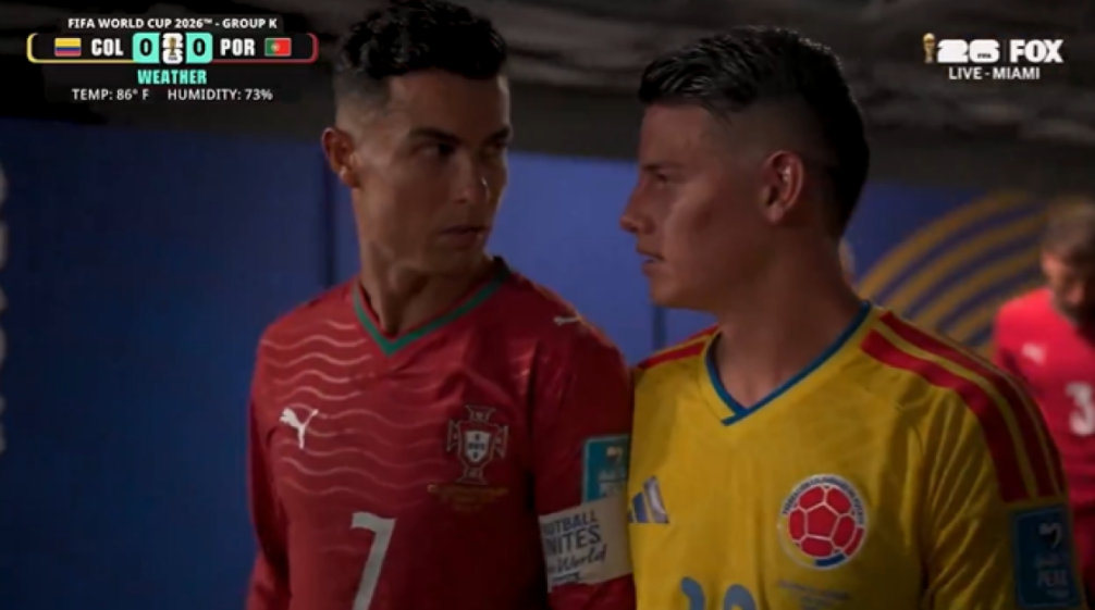 Two soccer players in red and yellow jerseys look at each other during the FIFA World Cup 2026.