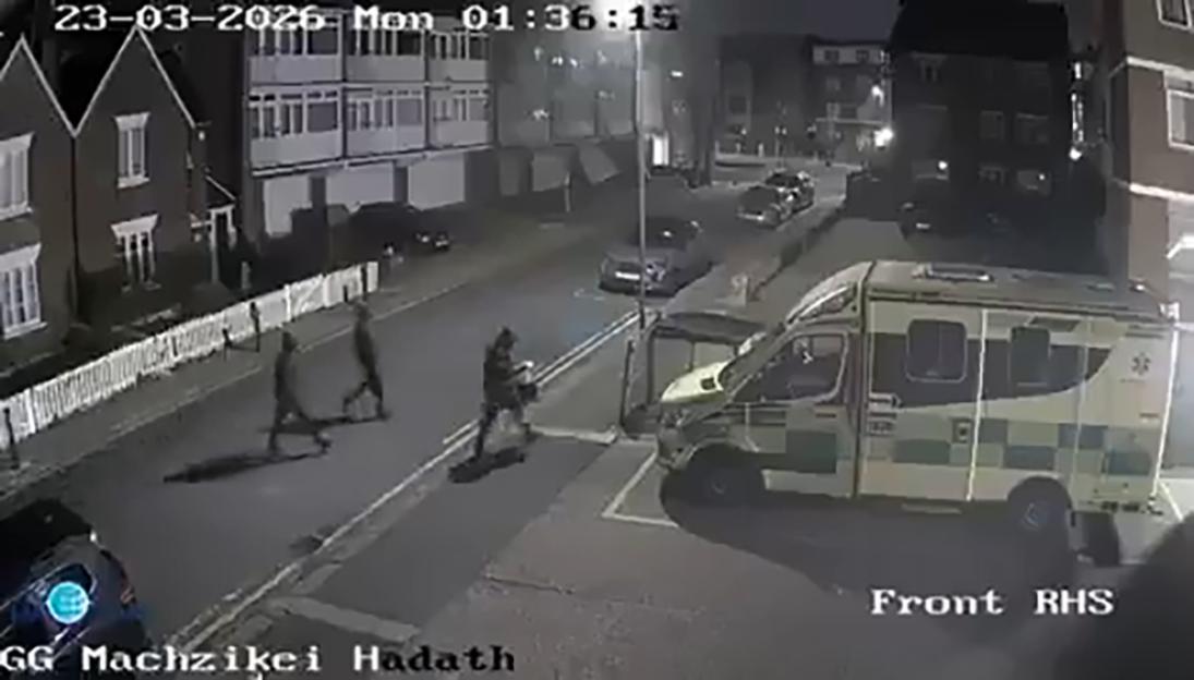 CCTV footage of people walking on the street near an ambulance in Golders Green, London.