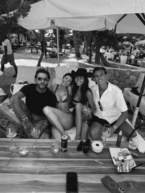 Black and white photo of Pete Wicks and Olivia Attwood with two other people in Ibiza.