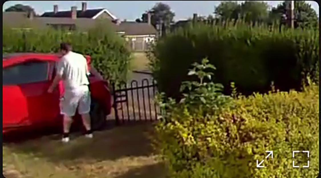 Ring Doorbell footage showing a man with an object in his pocket getting into a red car.