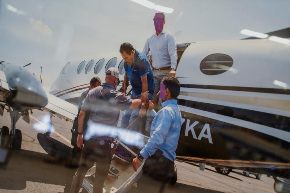 A photo of former Sinaloa Cartel leader Ismael "El Mayo" Zambada being detained by federal agents is displayed next to a Beechcraft King Air aircraft at the War Eagles Air Museum in Santa Teresa, New Mexico.