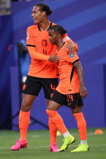 Crysencio Summerville celebrates with Virgil van Dijk after scoring a goal.