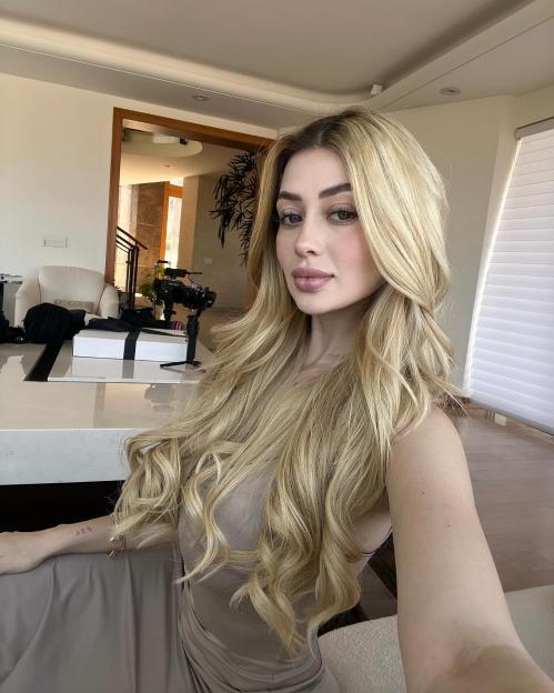 Mexican social media influencer Valeria Marquez in a selfie, sitting at a table with a camera set up behind her.