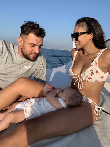 Charlotte Lescott, Ali Watson, and their daughter Soulie on a boat.