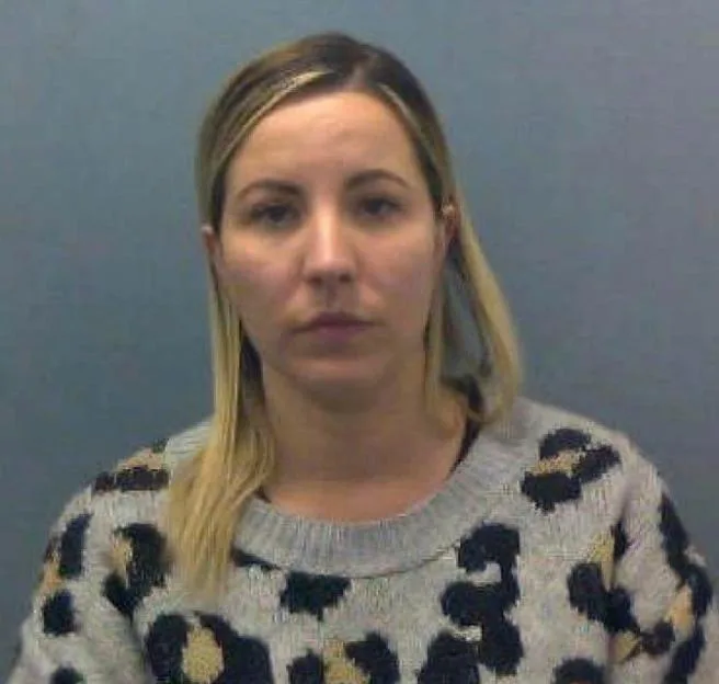Police mugshot of Kandice Barber wearing a leopard-print sweater.