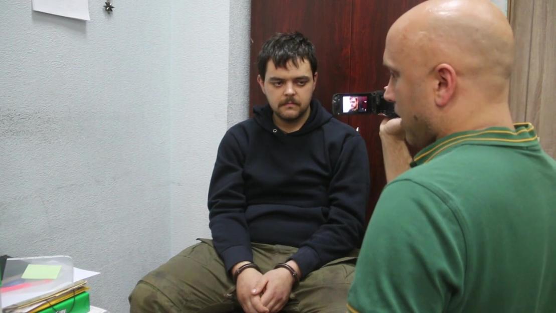 Videograb of British reporter Graham Phillips filming Aiden Aslin, a captured British national.