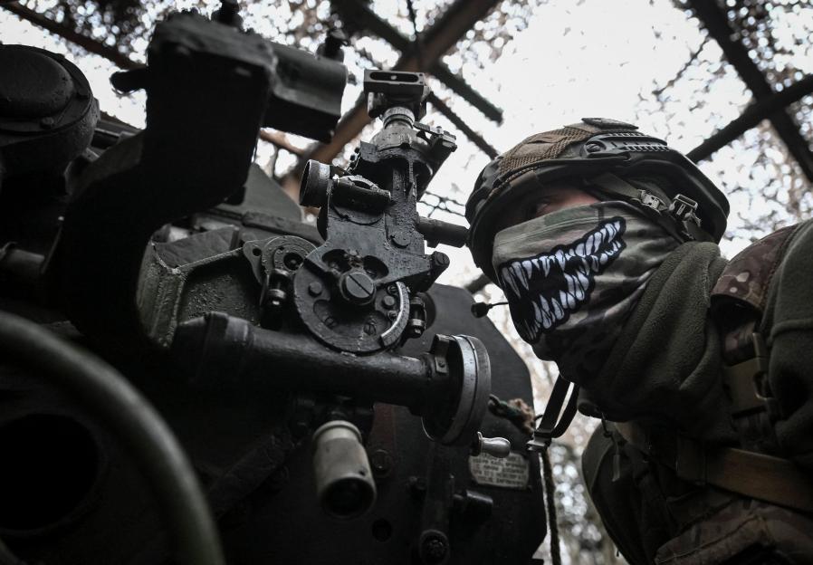 Ukrainian artilleryman prepares to fire a howitzer near Pokrovsk.