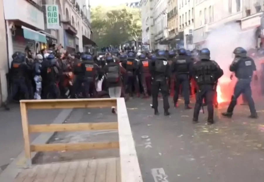 Dramatic moment cops charge protesters near Eurostar station and fire tear gas as riots across France erupt into chaos