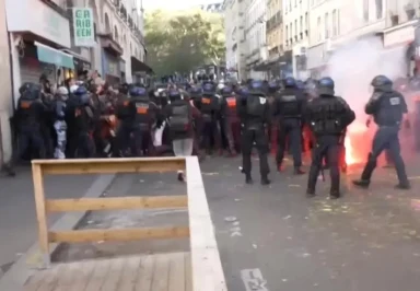 Dramatic moment cops charge protesters near Eurostar station and fire tear gas as riots across France erupt into chaos