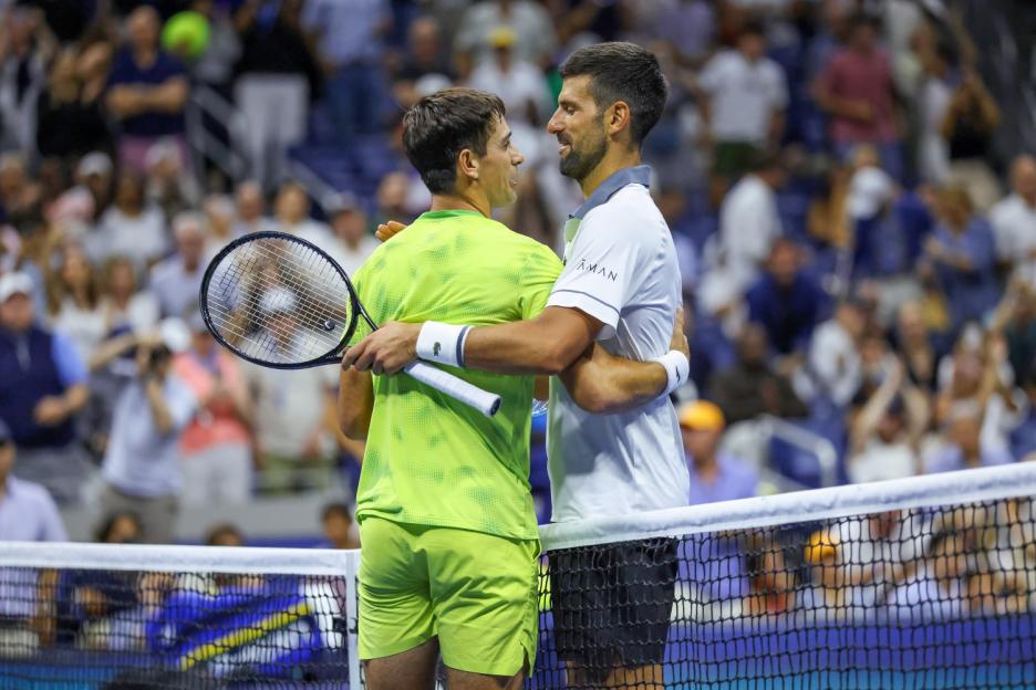 Novak Djokovic and Mariano Navone embrace at the net after their match at the 2026 US Open Tennis Championships.