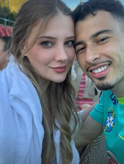 A man and a woman posing for a selfie.