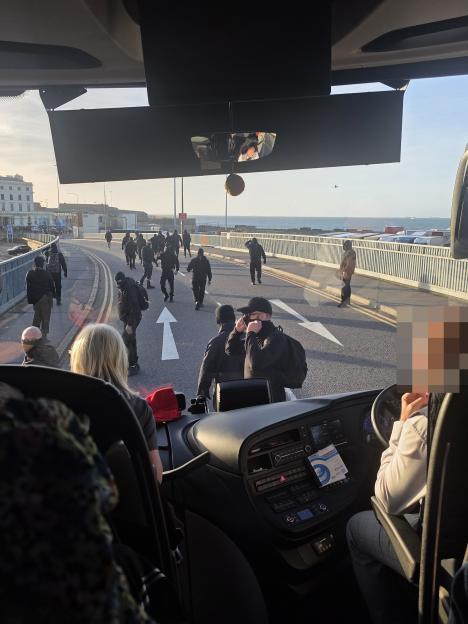 Protesters in black clothing and masks stopping a coach in Dover from getting to its ferry.