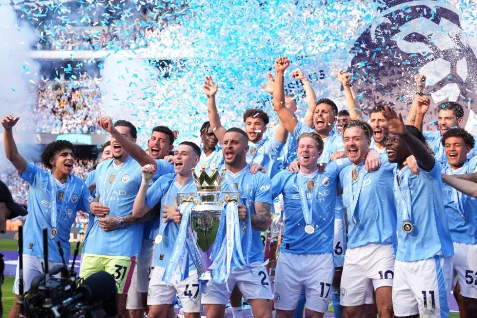 Manchester City's Kyle Walker lifts the Premier League trophy with team-mates after the Premier League match at the Etihad Stadium.