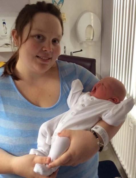 Becky Harris holds her baby.
