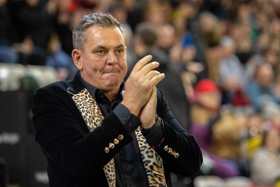 Leigh owner Derek Beaumont clapping during a rugby league match.