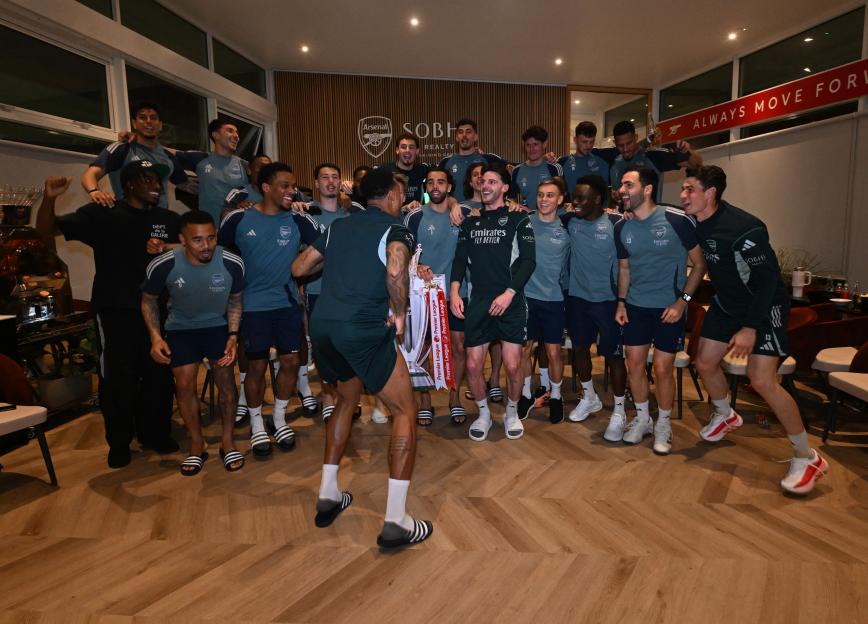 Arsenal players celebrate after watching AFC Bournemouth v Manchester City.