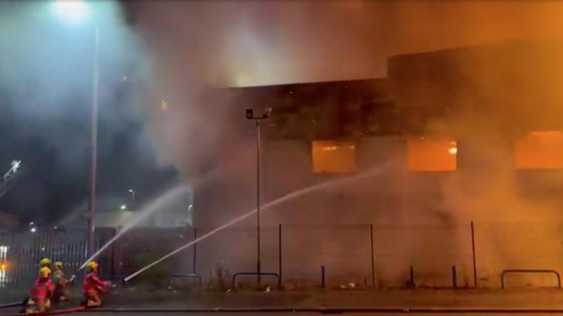 Firefighters battling a large fire at a commercial building.
