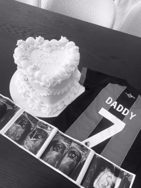 Baby shower announcement with cake, ultrasound photos, and "Daddy" jersey.