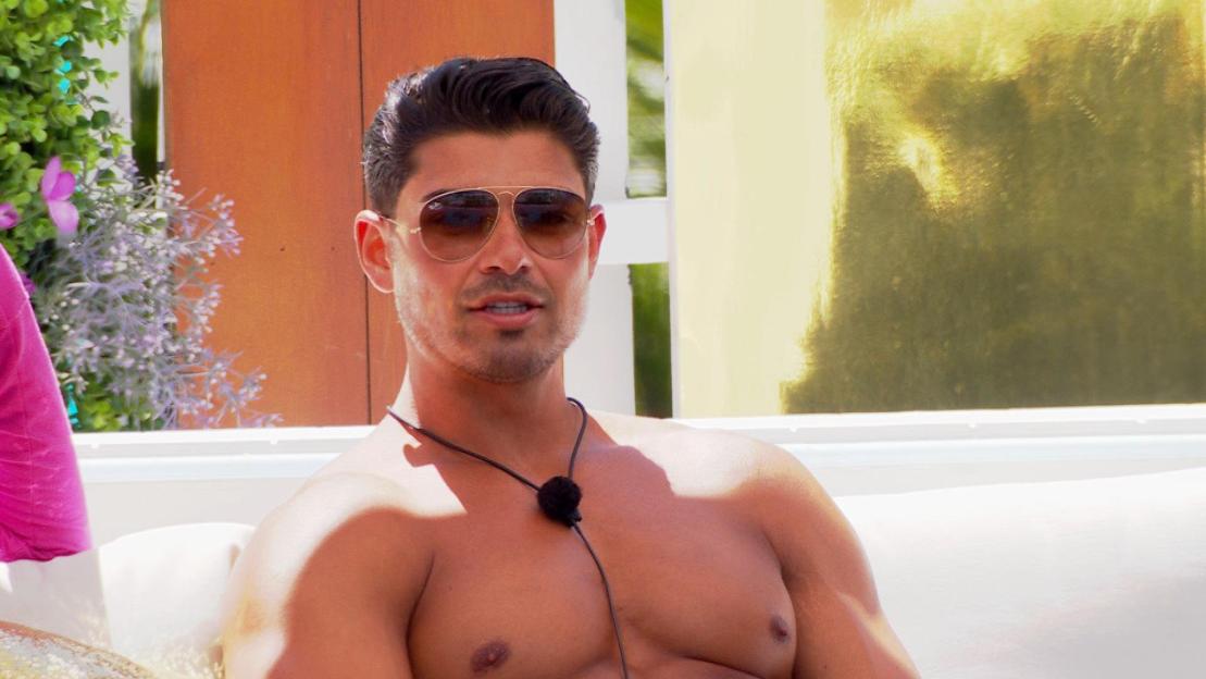 Anton Danyluk in sunglasses, shirtless, on Love Island: All Stars.