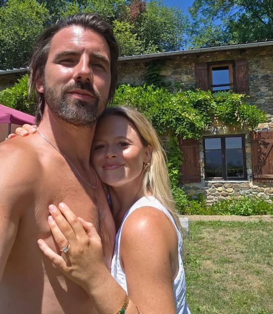 Emily Atack shows off her engagement ring while posing with Alistair Garner.