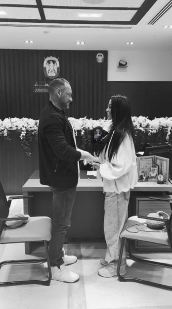 Katie Price and Lee Andrews holding hands at their wedding in Dubai.