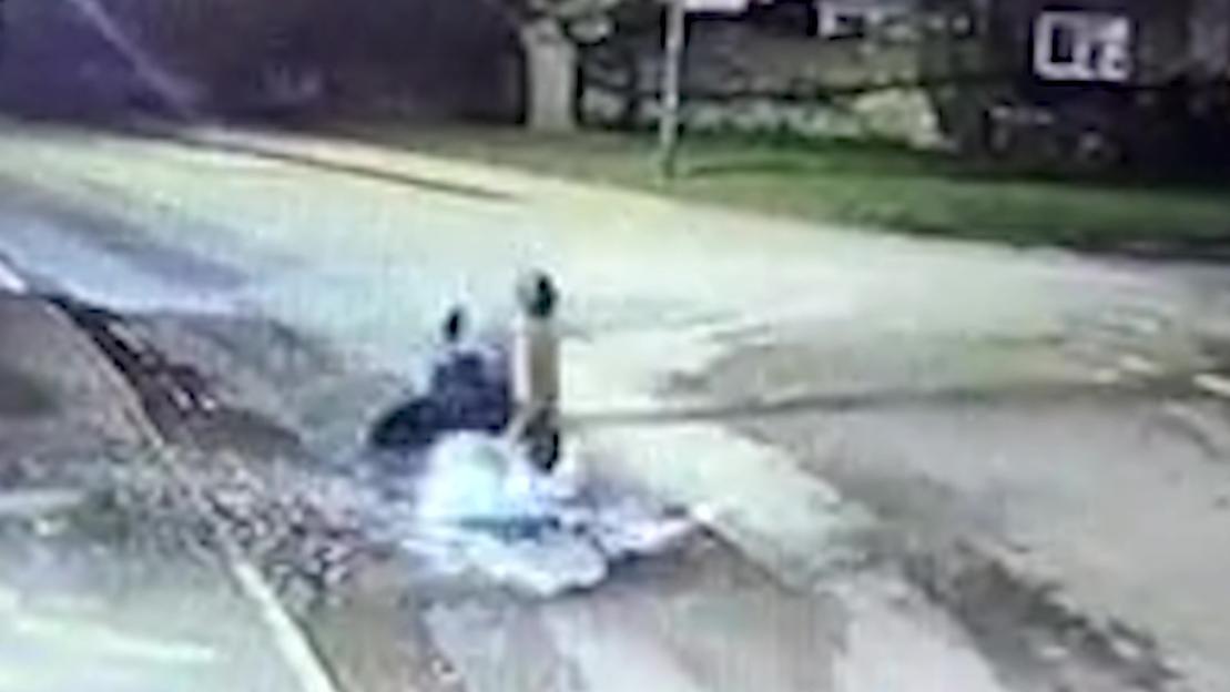 CCTV footage of an e-scooter rider face-planting into the road after hitting a large pothole.