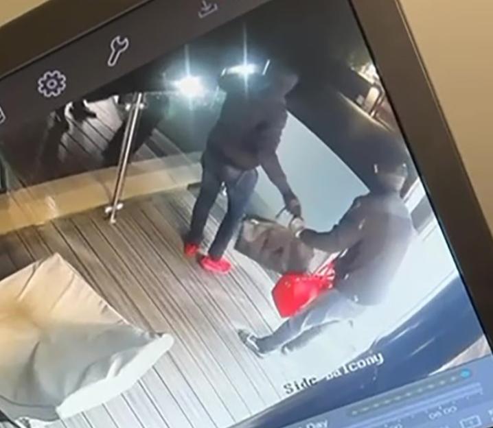 CCTV footage showing two burglars with bags of jewelry.