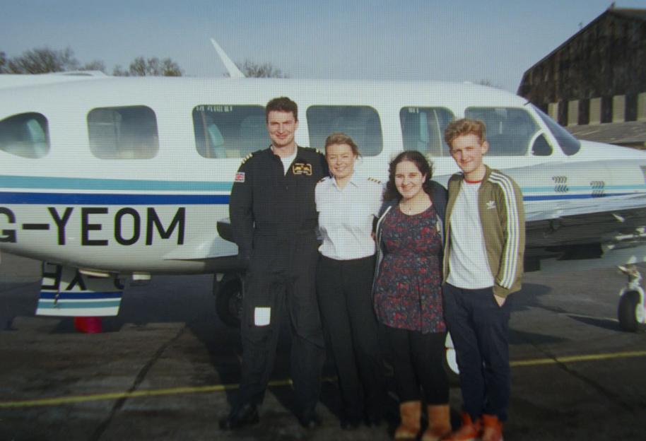 Polar Flight Crew posing in front of a small white airplane.