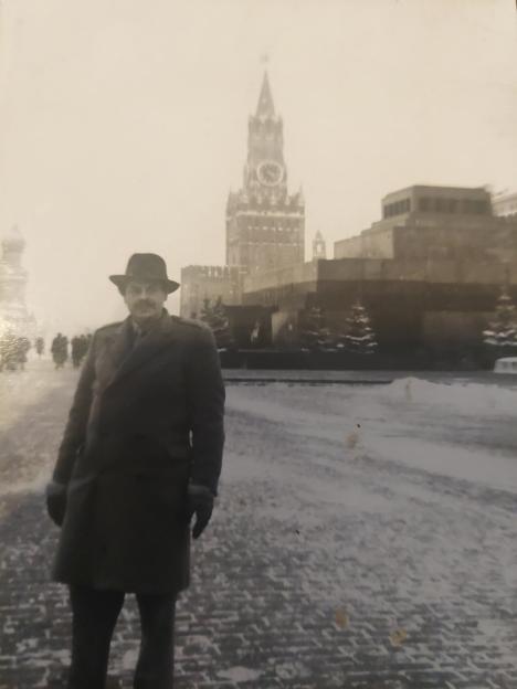 William Maxwell Nasmyth Wilcock standing in a snowy Red Square in Moscow, with the Spasskaya Tower and Lenin's Mausoleum in the background.