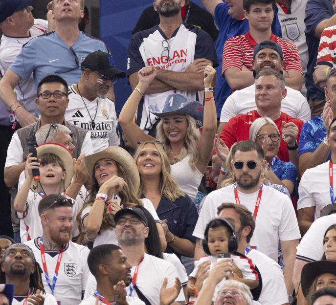 England fans, including Megan Pickford in a cowboy hat and Harry Kane's wife Kate in denim, cheer on their team at a FIFA World Cup match in Dallas.