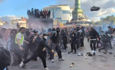 Dramatic moment French riot cops charge student protesters as dozens of officers injured in worsening violence