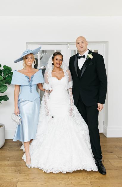 Paris Fury, Venezuela Fury, and Tyson Fury pose for a photo at a wedding.