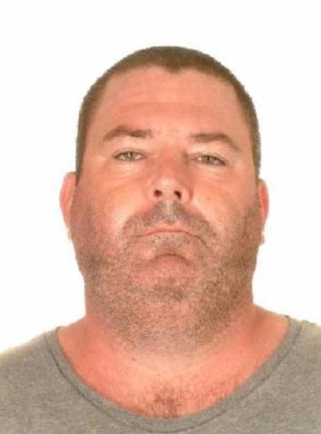 Headshot of Philip Barry Foster, a wanted criminal, looking directly at the camera.