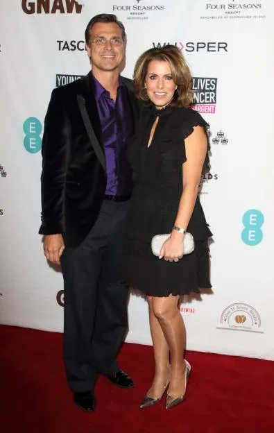 Justin Bower and Natasha Kaplinsky pose together at a charity auction.