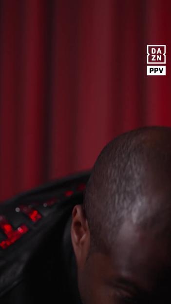Daniel Dubois turns away from an interview, as shown by his head and right ear in the foreground, with a red background and the DAZN PPV logo in the top right.