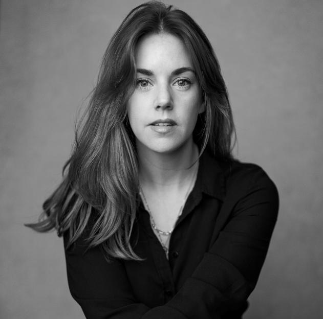 Black and white portrait of a woman looking directly at the camera.