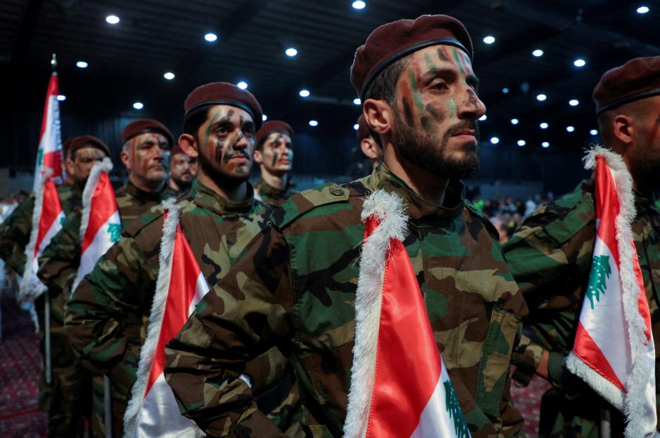 : Hezbollah members parade during a rally marking al-Quds Day in Beirut's southern suburbs