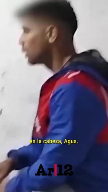 Young man with a fade haircut wearing a blue and red jacket.