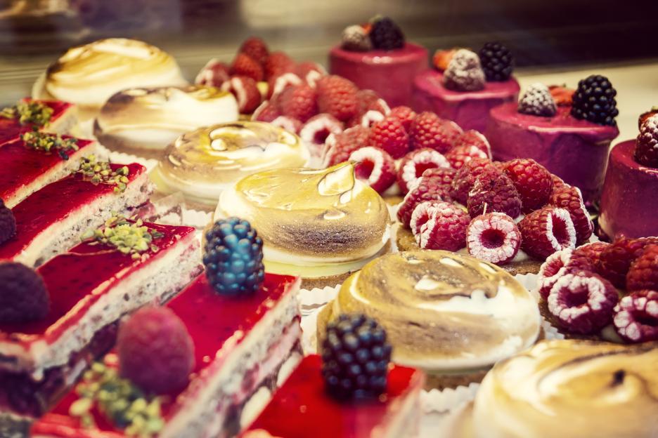 a variety of desserts with raspberries on top of them