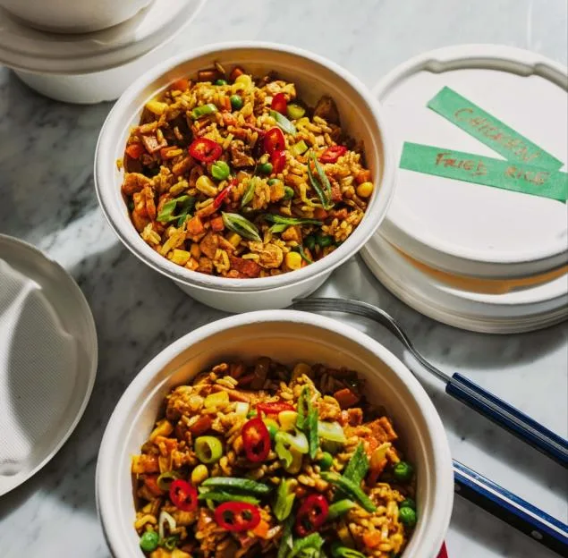 Chicken fried rice in two round, white bowls.