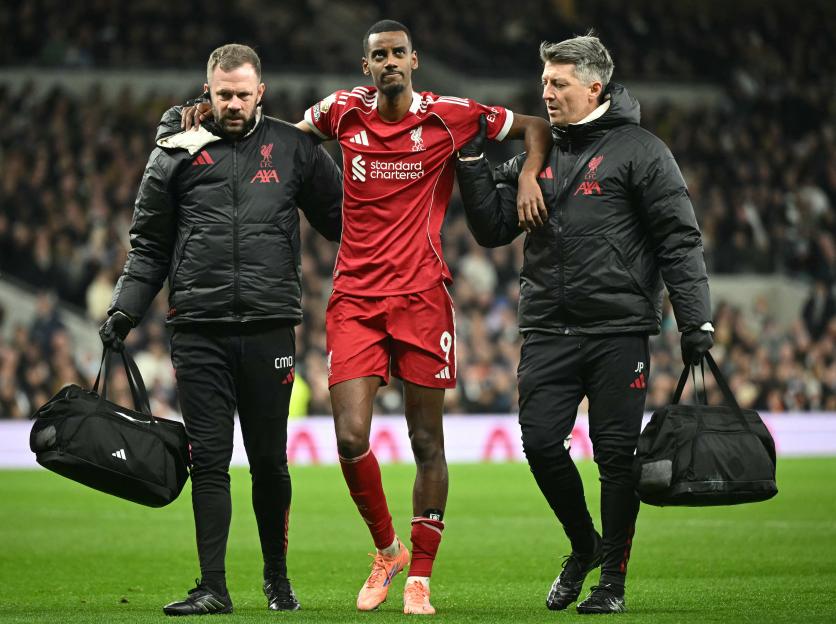Liverpool's Swedish striker Alexander Isak is helped off the field by medical staff after picking up an injury.