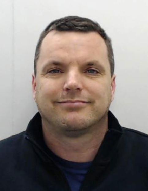 Headshot of wanted criminal Simon Dutton.