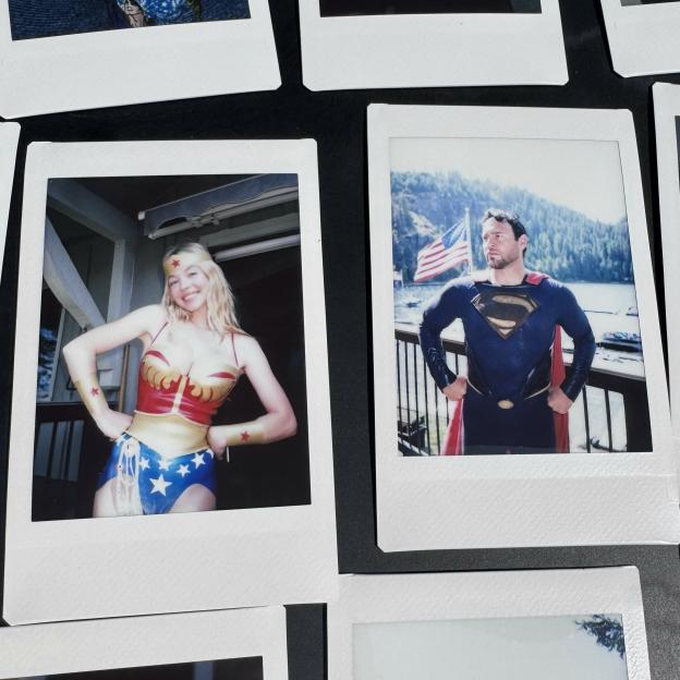 Collage of two polaroid photos. The left photo shows Sydney Sweeney dressed as Wonder Woman. The right photo shows a man dressed as Superman.