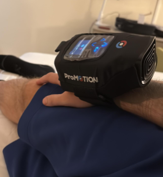 A "ProMOTION" device strapped to a person's thigh.